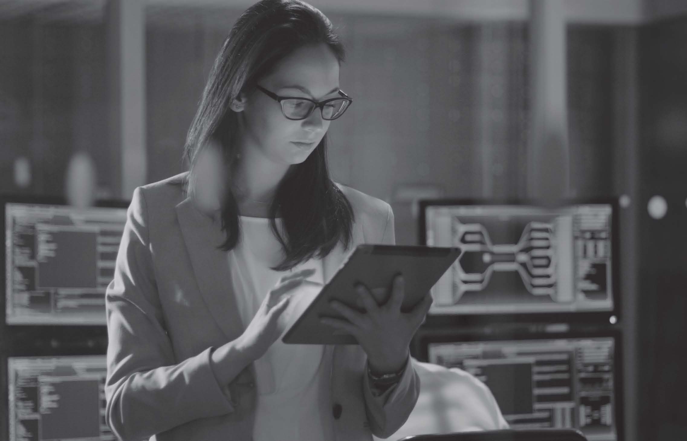 Grayscale photo of woman holding tablet computer