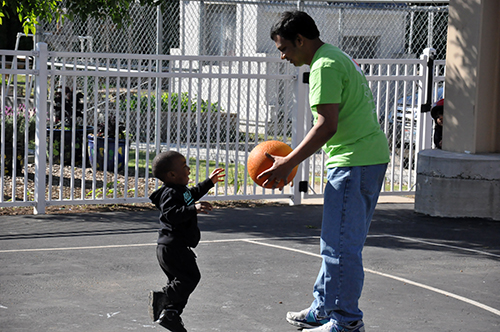 netscout employee playing basketball with young kid