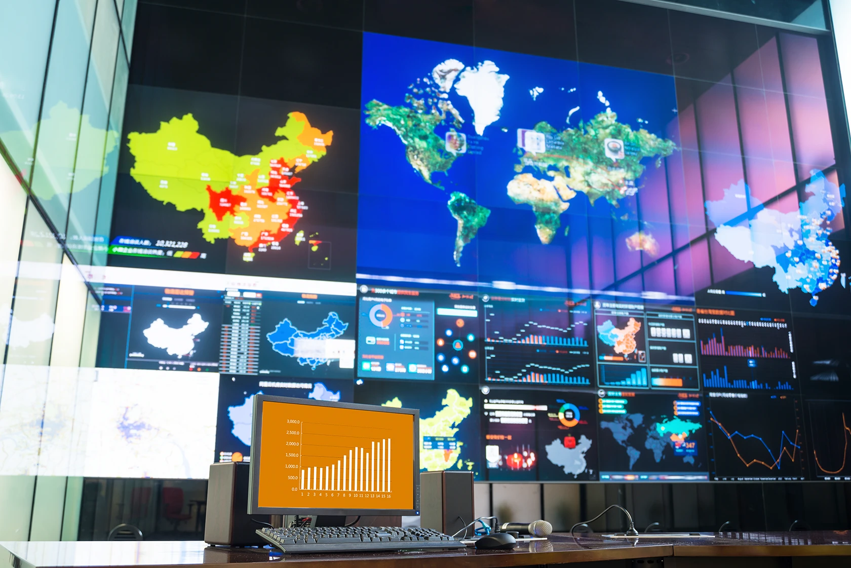 Virtual floor-to-ceiling screen with lots of charts and maps