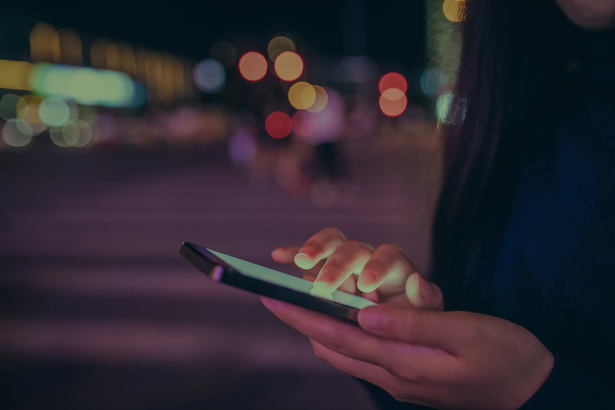 A pair of hands holding a mobile phone