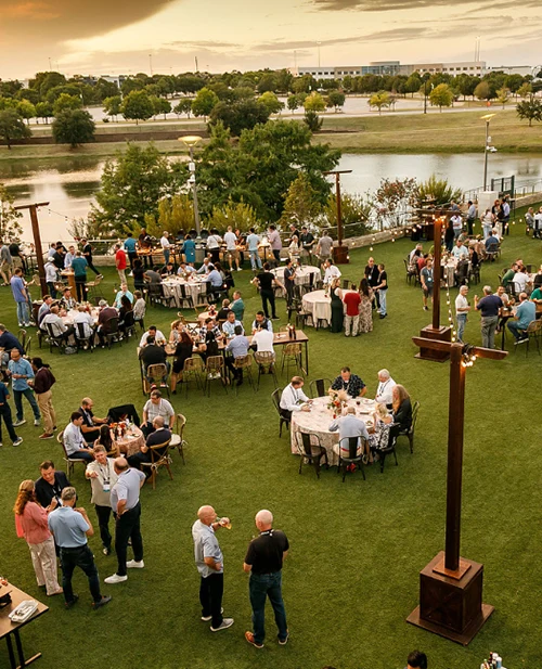Outdoor venue with people mingling and sitting at tables
