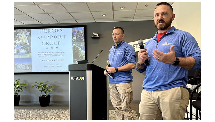 Two men in blue shirts presenting Hero's Support Group