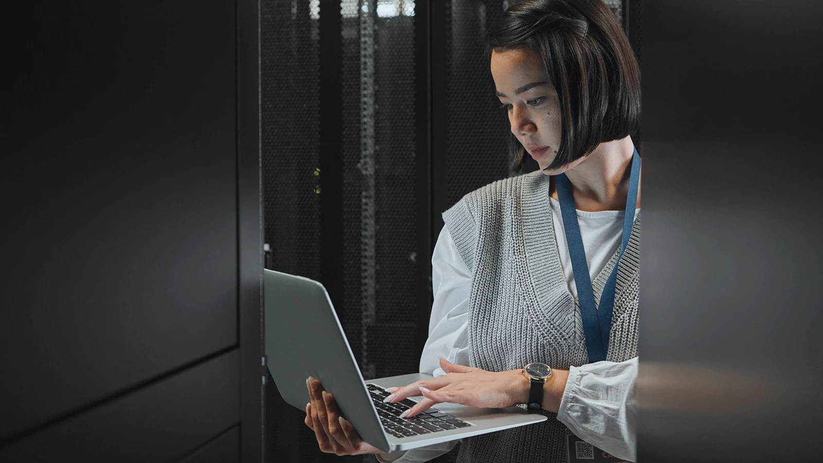 Woman on laptop in datacenter