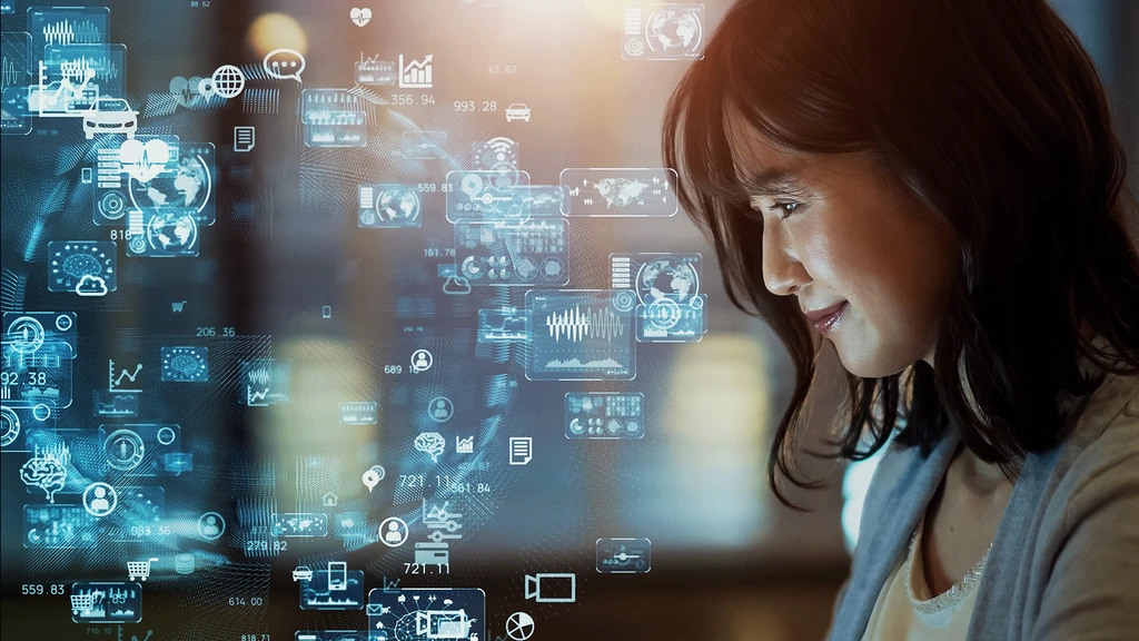 Woman looking down at what could be a laptop monitor and in background floating images of shopping carts, automobiles, credit cards, and more