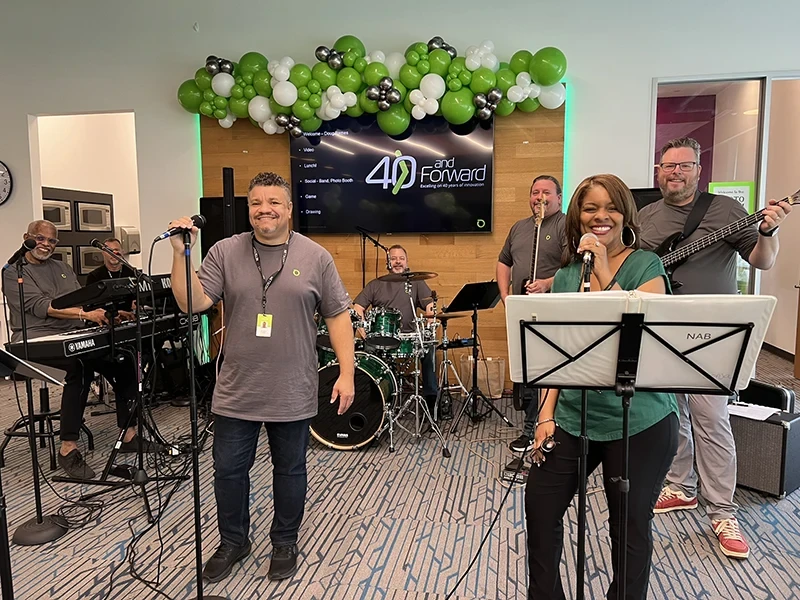 Employees in a band playing at a company celebration