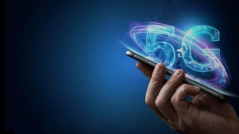 Hand holding cellphone with 5G above it