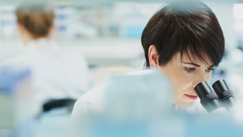 Pharmacist looking at her microscope