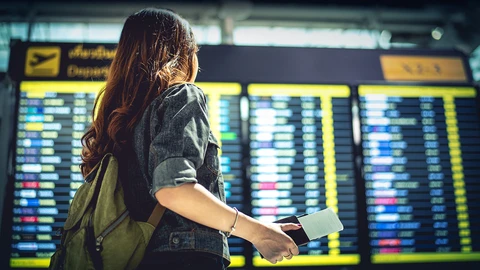 Girl in the airport checking flight status