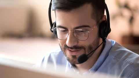 Gentlemen on headset in front of a monitor