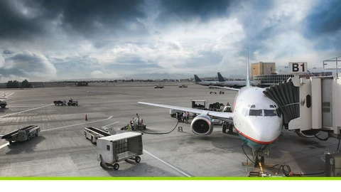Airplane pulled into jet bridge at airport terminal