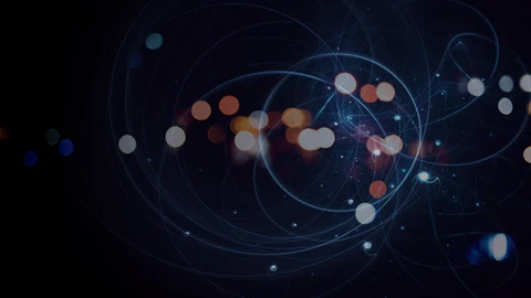 Orange and blue circular light flares amidst a dark background and lighter blue swirling circles