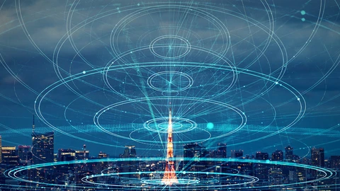 picture of metropolis with beam of light shining down from sky and rings of sound waves surrounding