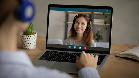 Person at laptop having one on one video conference with another person