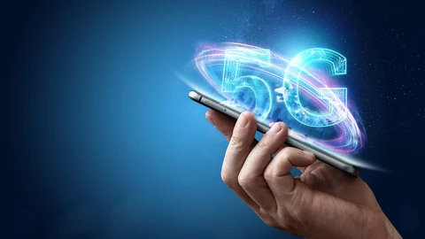 Hand holding cell phone with 5G image above.