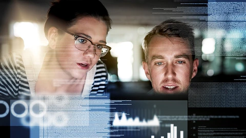 IT Team reviewing network data together on laptop.