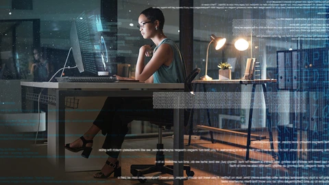 woman sitting at desk looking at monitor