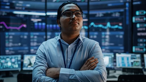 Male is business shirt with hands crossed