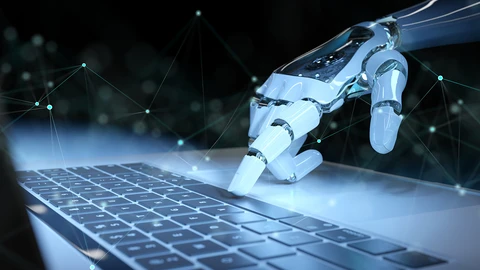 Robot hand on keyboard