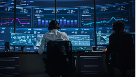 2 people in SOC watching monitors