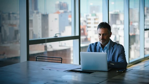 Man at laptop working in remote area