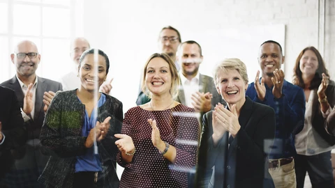 People behind glass clapping