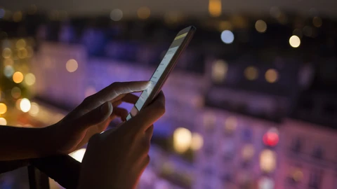 Person on phone in front of control panel