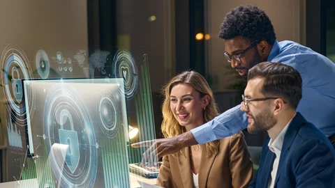 People around monitor reviewing information