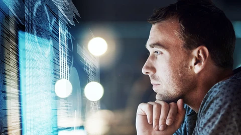 Guy with hand on chin looking at monitor