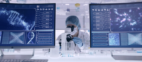 Pharmaceutical chemist using microscope