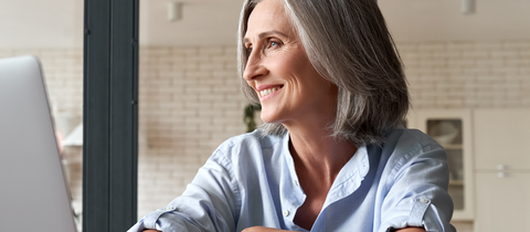 Woman smiling looking away from monitor