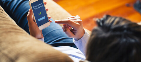 Person on a sofa looking at mobile device
