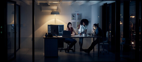 Team working at night on computer