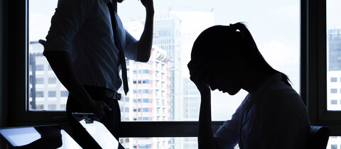 2 people with hands on their heads