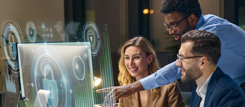 People around monitor reviewing information