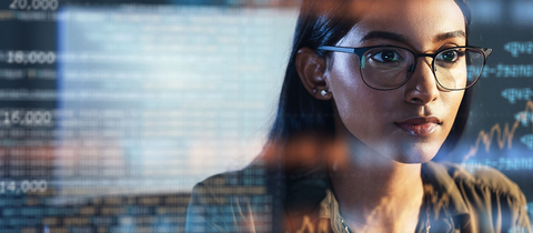 Woman wearing glass with data in the background