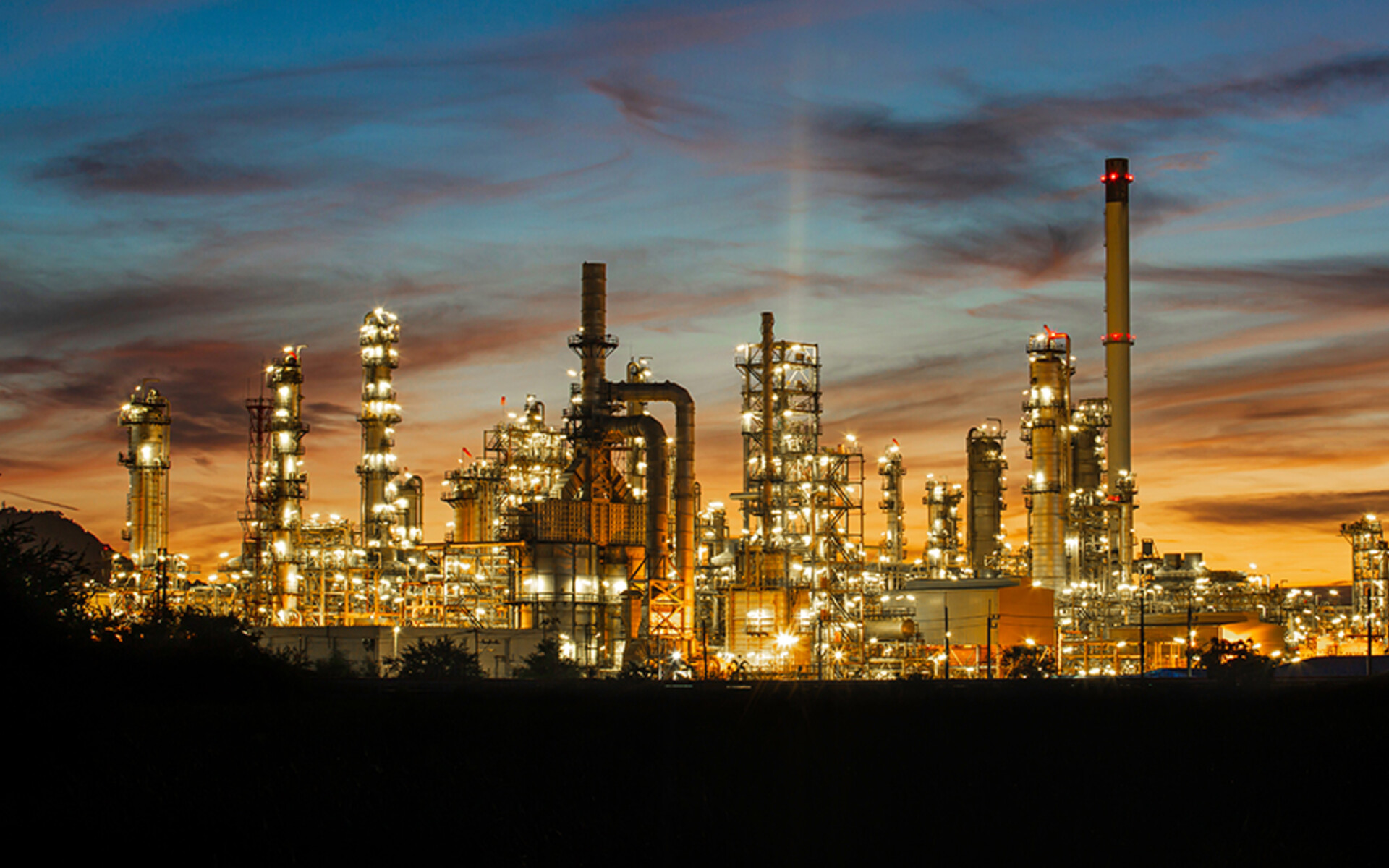 Power plant illuminated against the sky