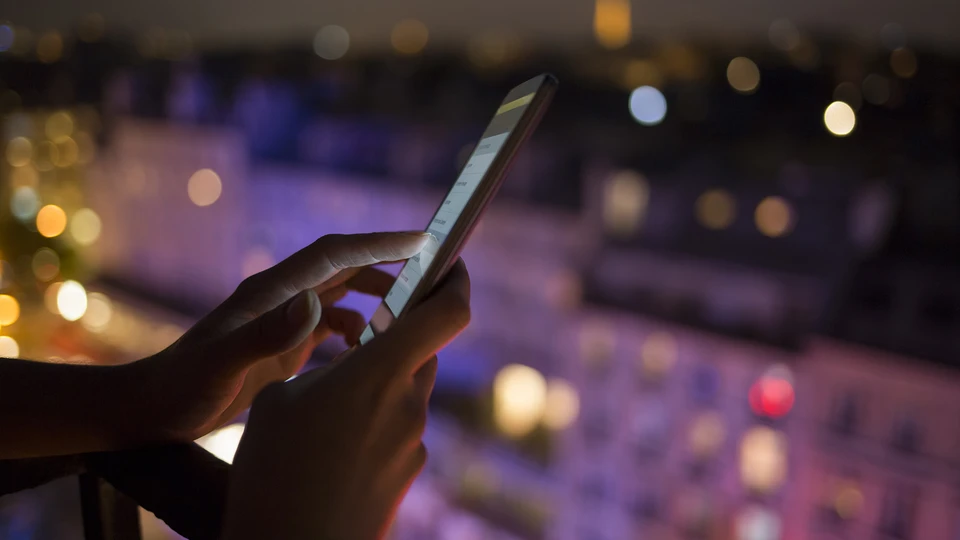 Person on phone in front of control panel