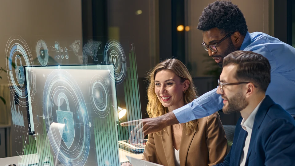 People group together reviewing something on monitor